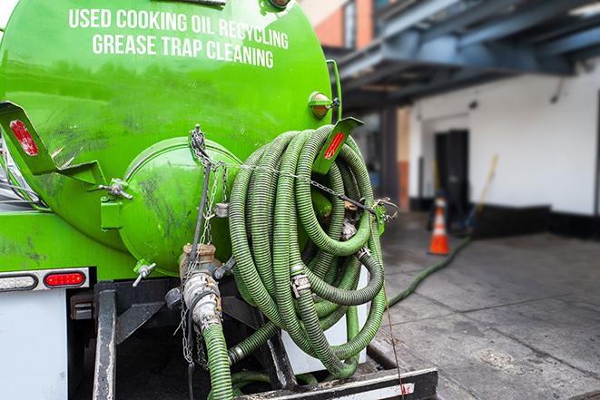 a grease trap pumping service in action at a commercial building in Canutillo